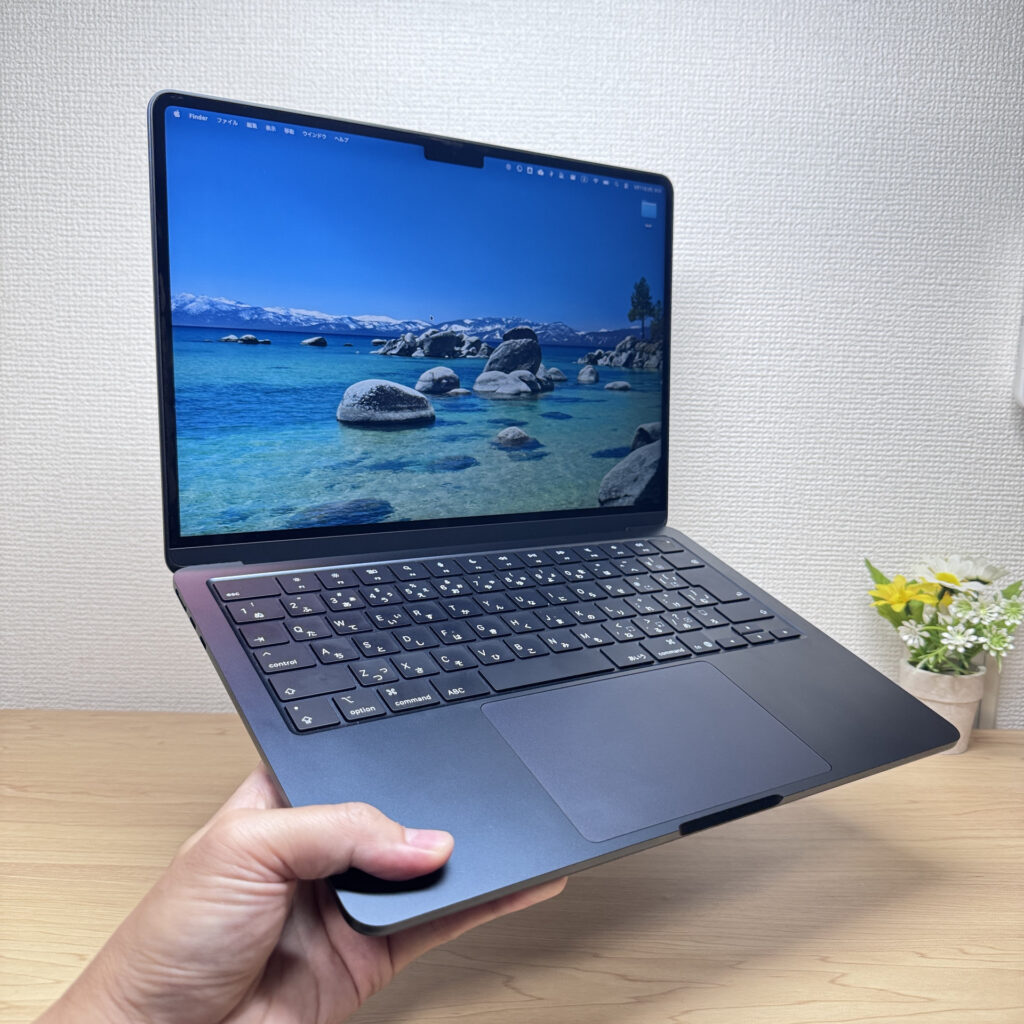 MacBook Air M4 held in one hand
